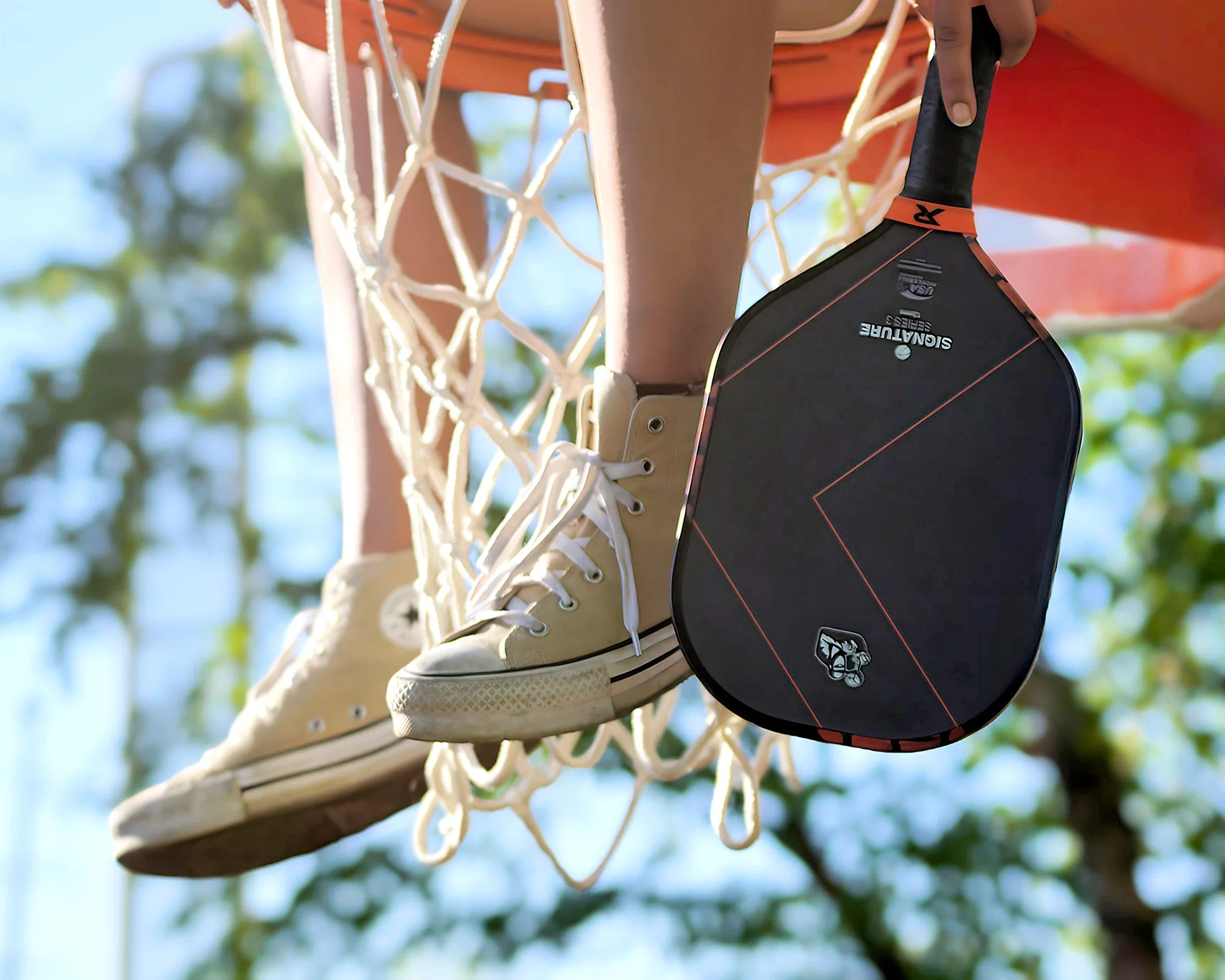 Paddle held next to a hoop